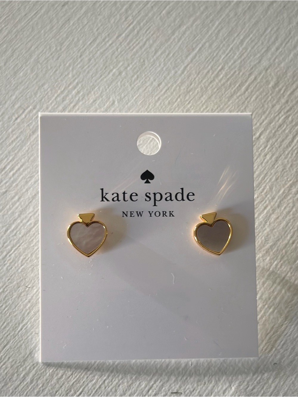 Kate Spade gold signature spade  silhouette stud earrings with Mother of Pearl